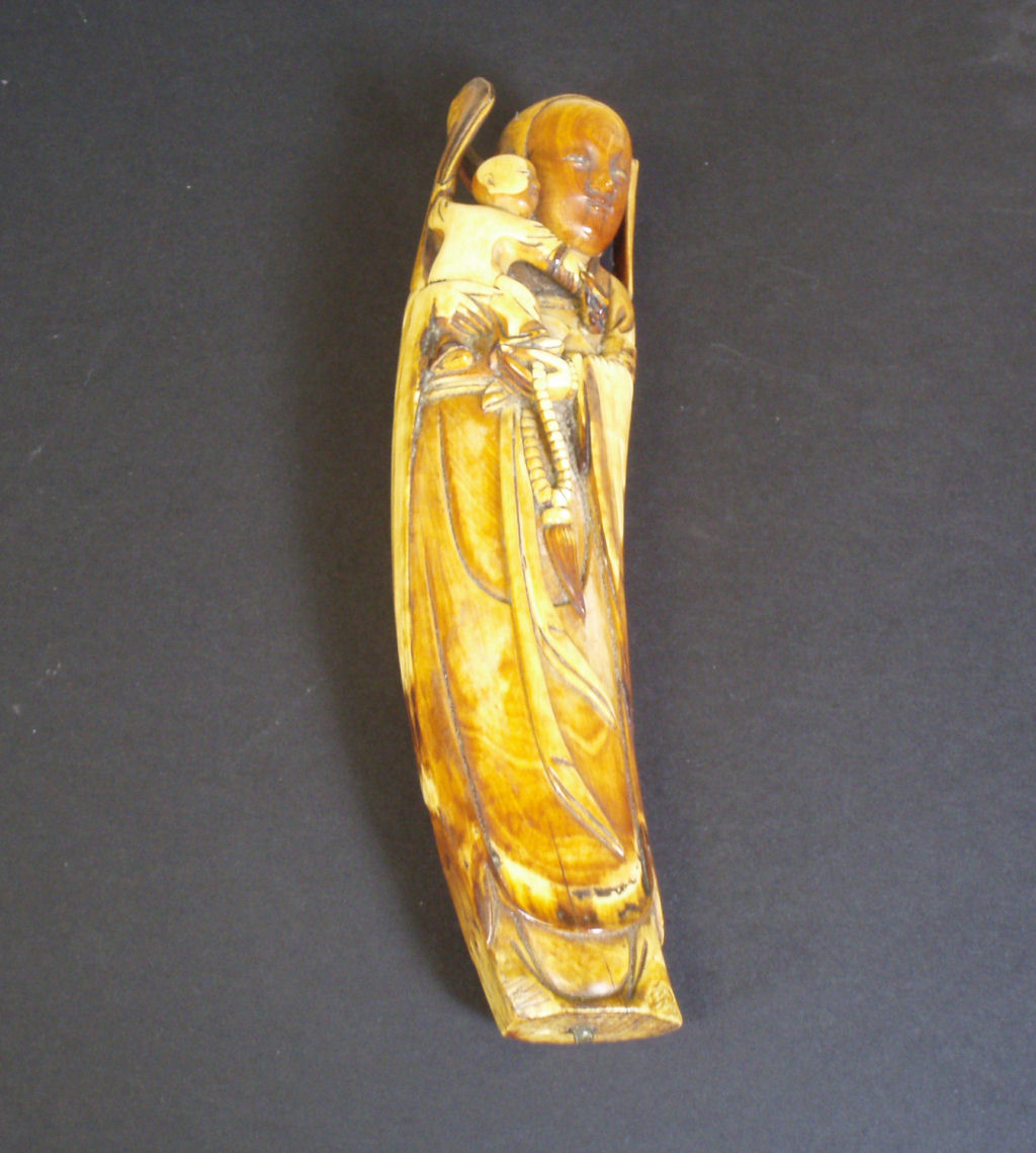 A 19th century Chinese stained ivory Guanyin figure
