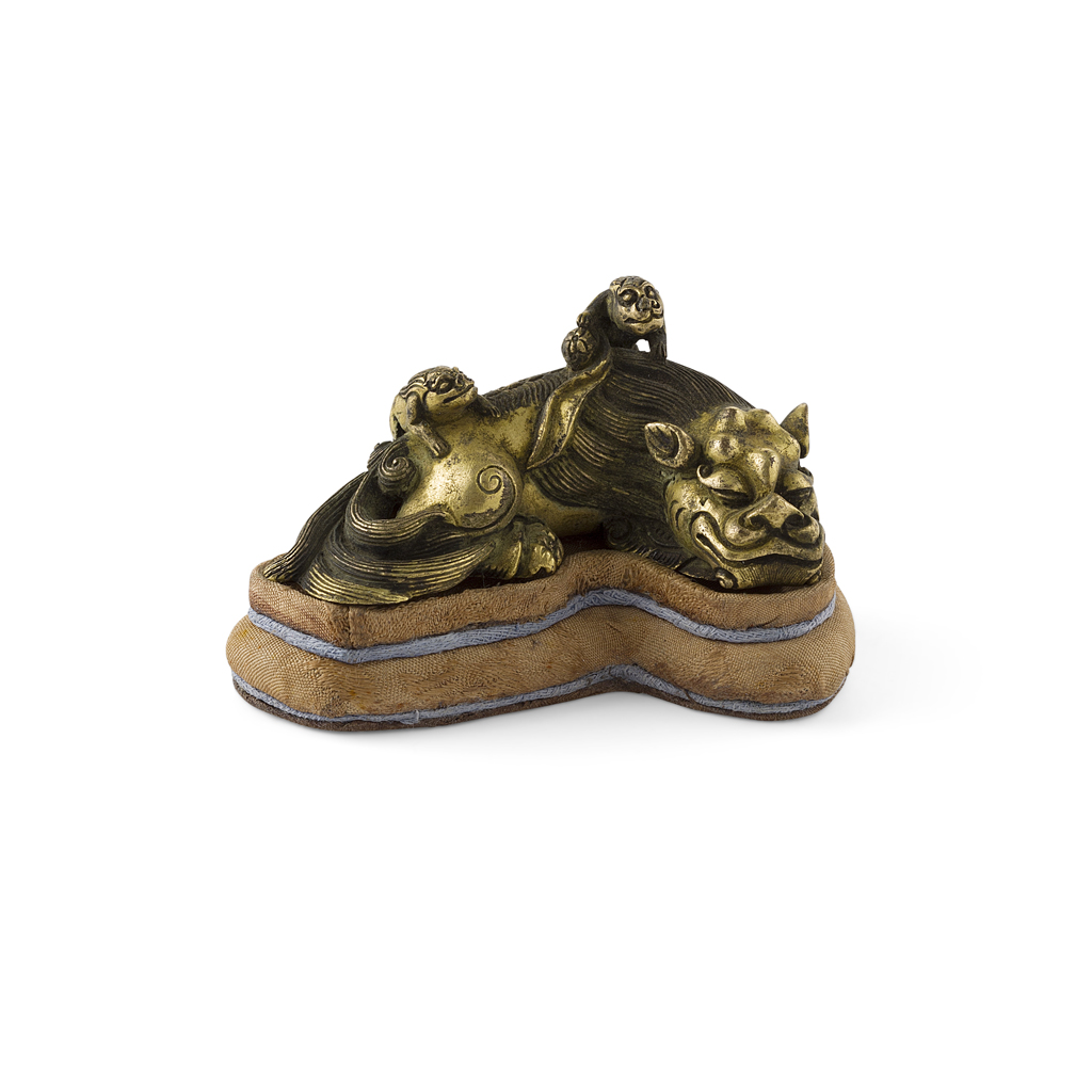 GILT BRONZE 'BUDDHIST LION' SCROLL WEIGHT