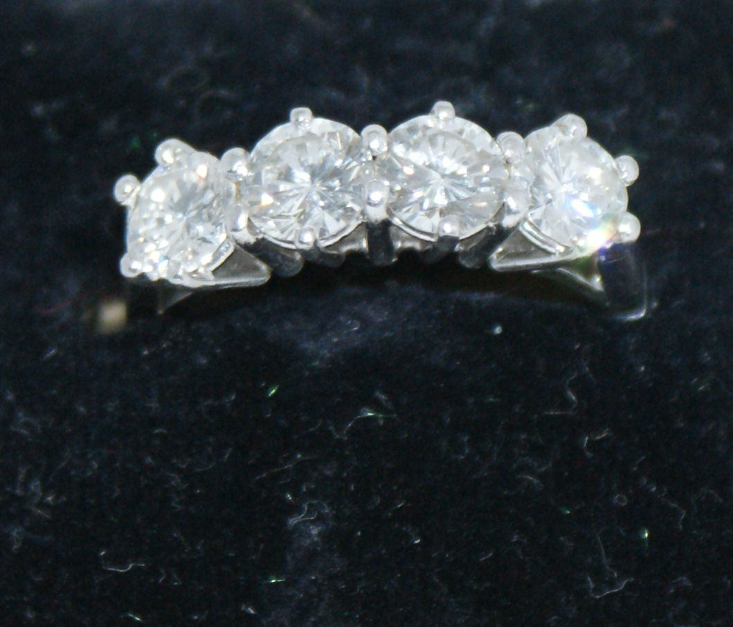 An 18ct white gold and platinum mounted four-stone diamond ring,