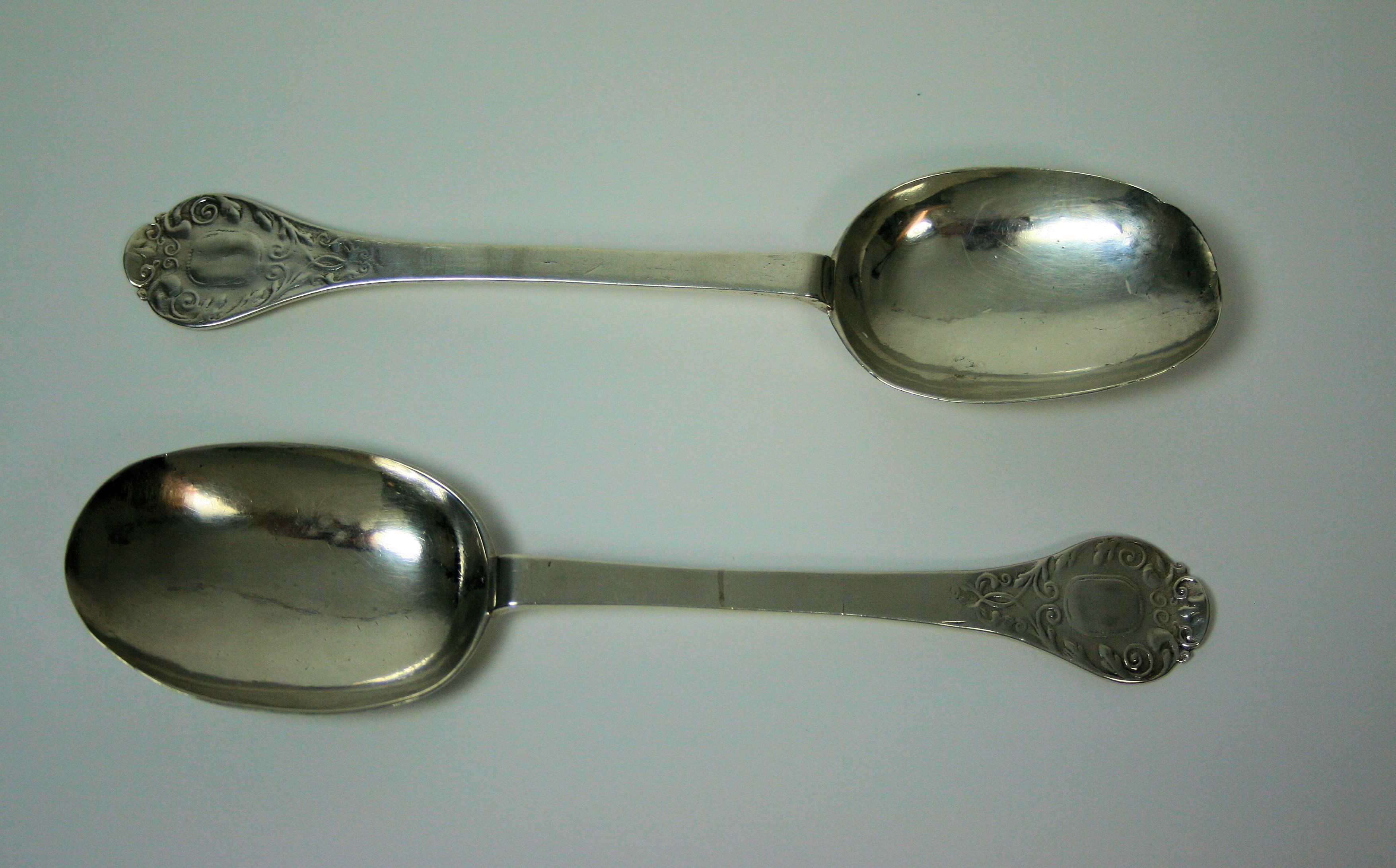 A rare pair of lace backed William III trefid spoons