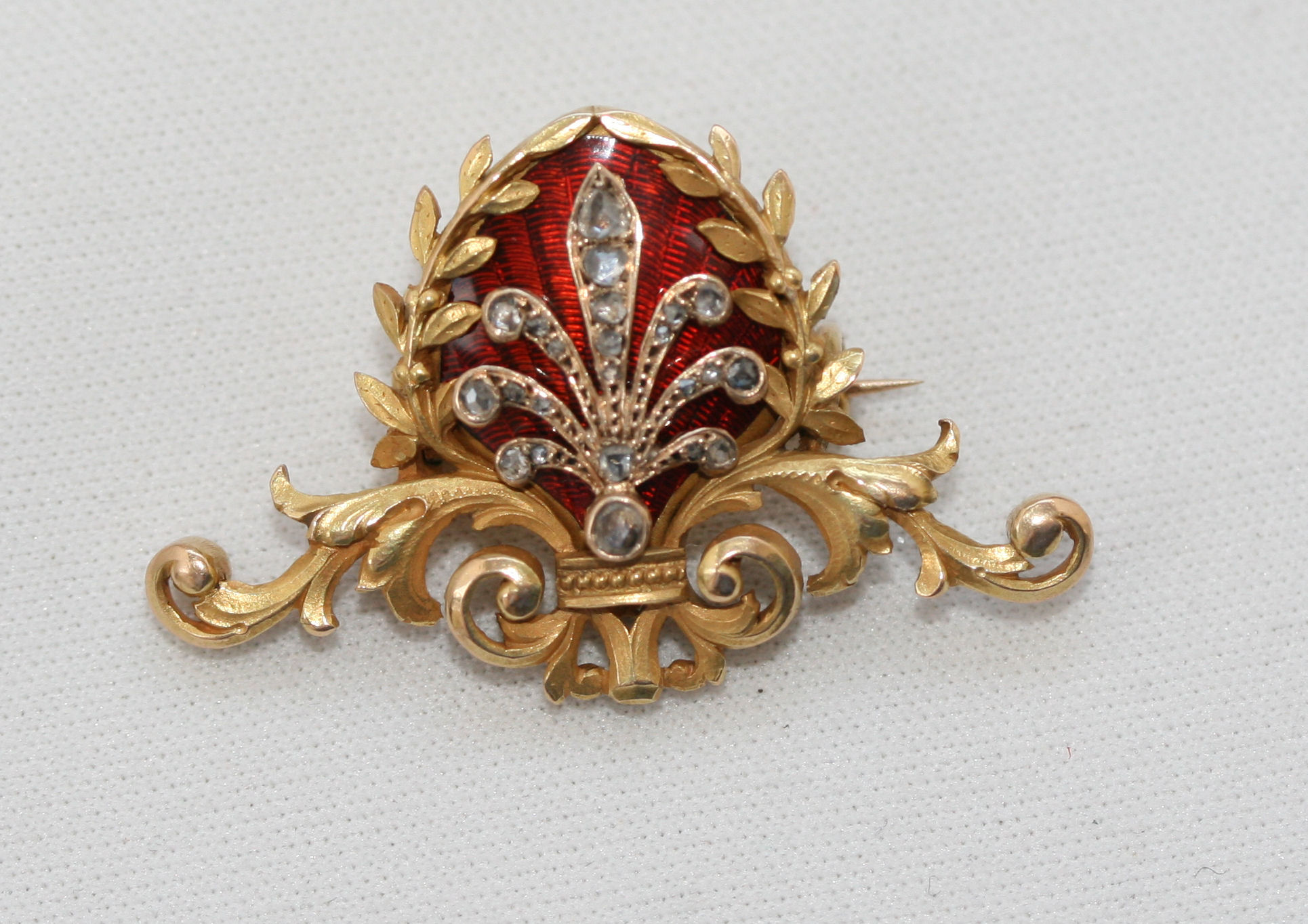An early 20th century enamel decorated and diamond set brooch,