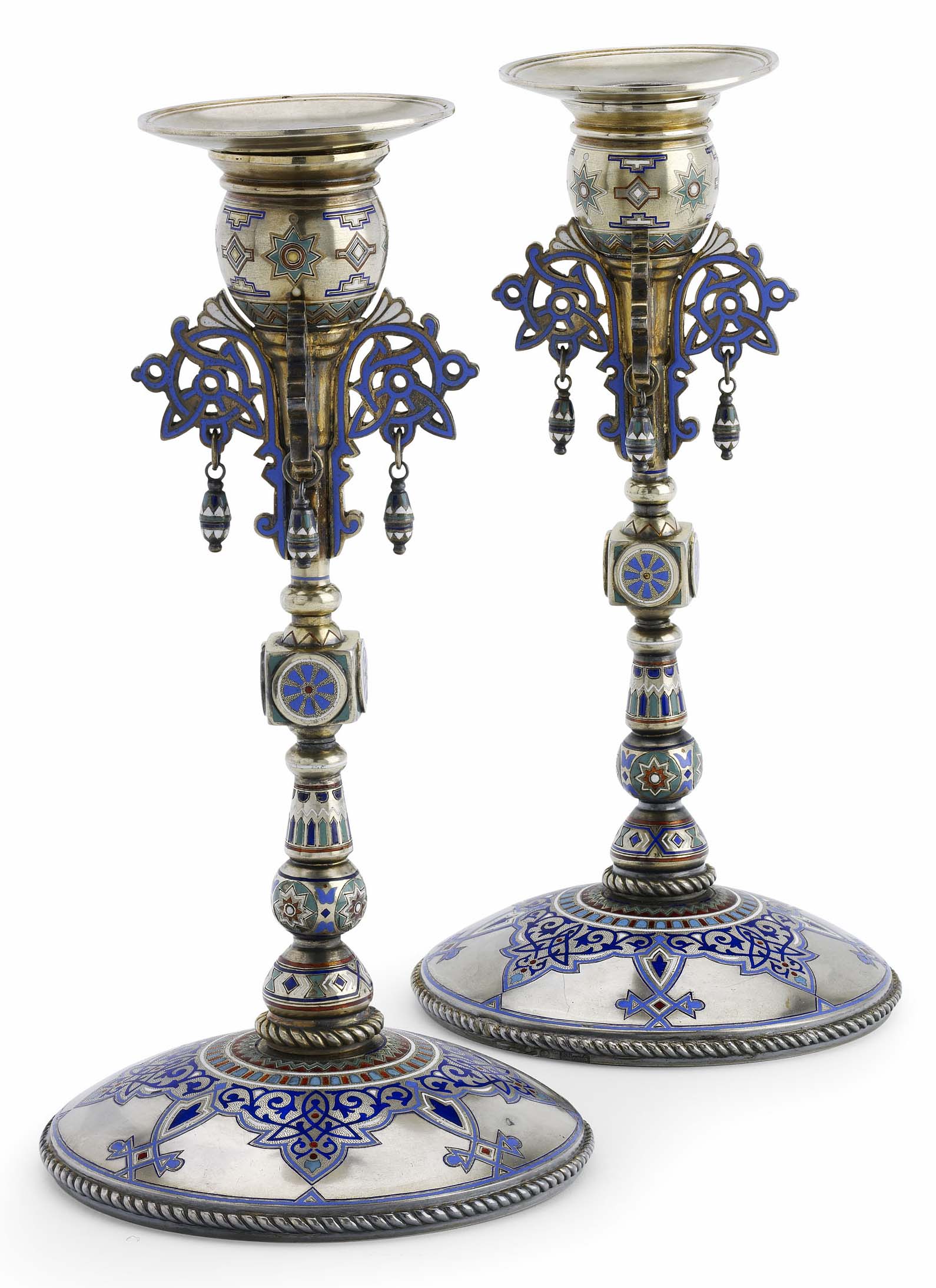 A pair of Russian silver-gilt and champlevé enamel candlesticks