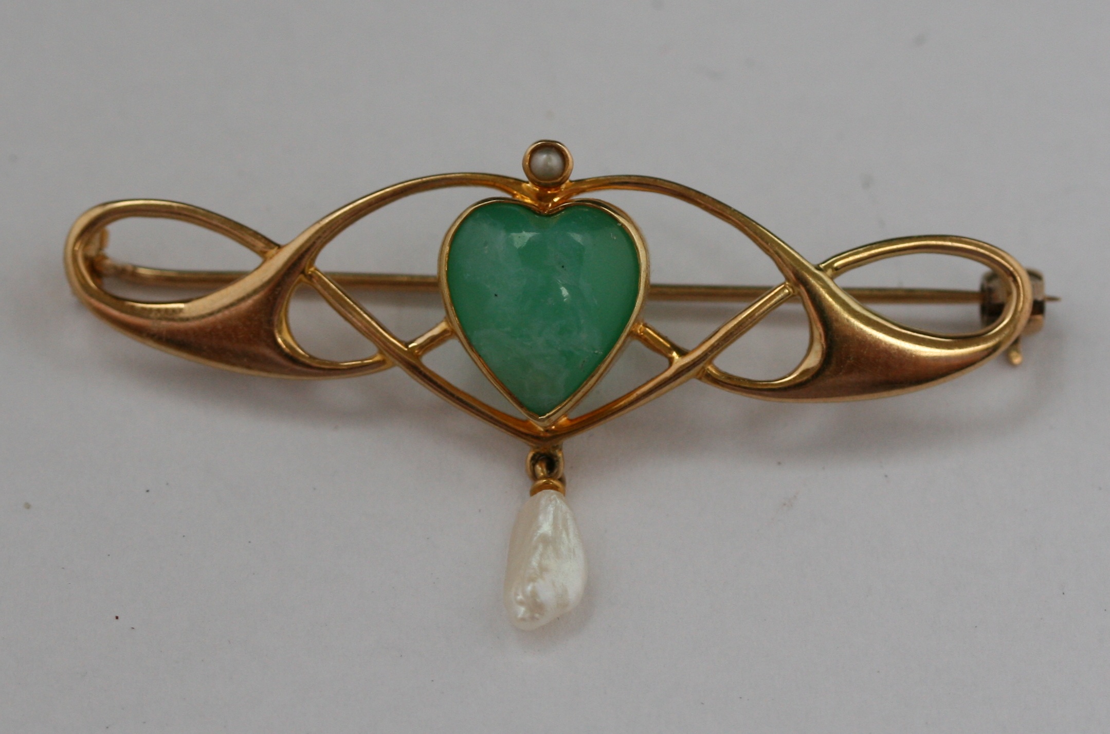 An Art Nouveau style jade brooch