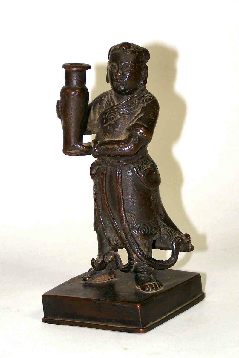 A Chinese bronze figure of a man holding a vase Ming Dynasty