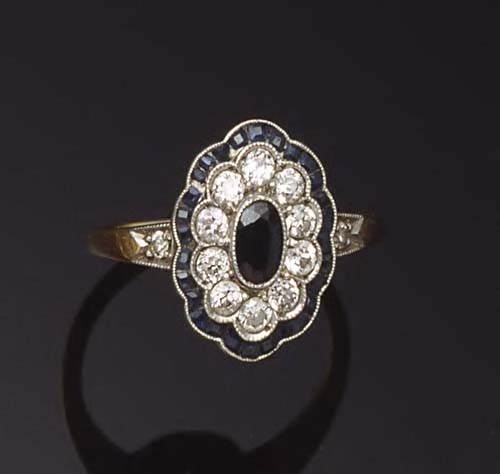 A sapphire and diamond shaped oval cluster ring,