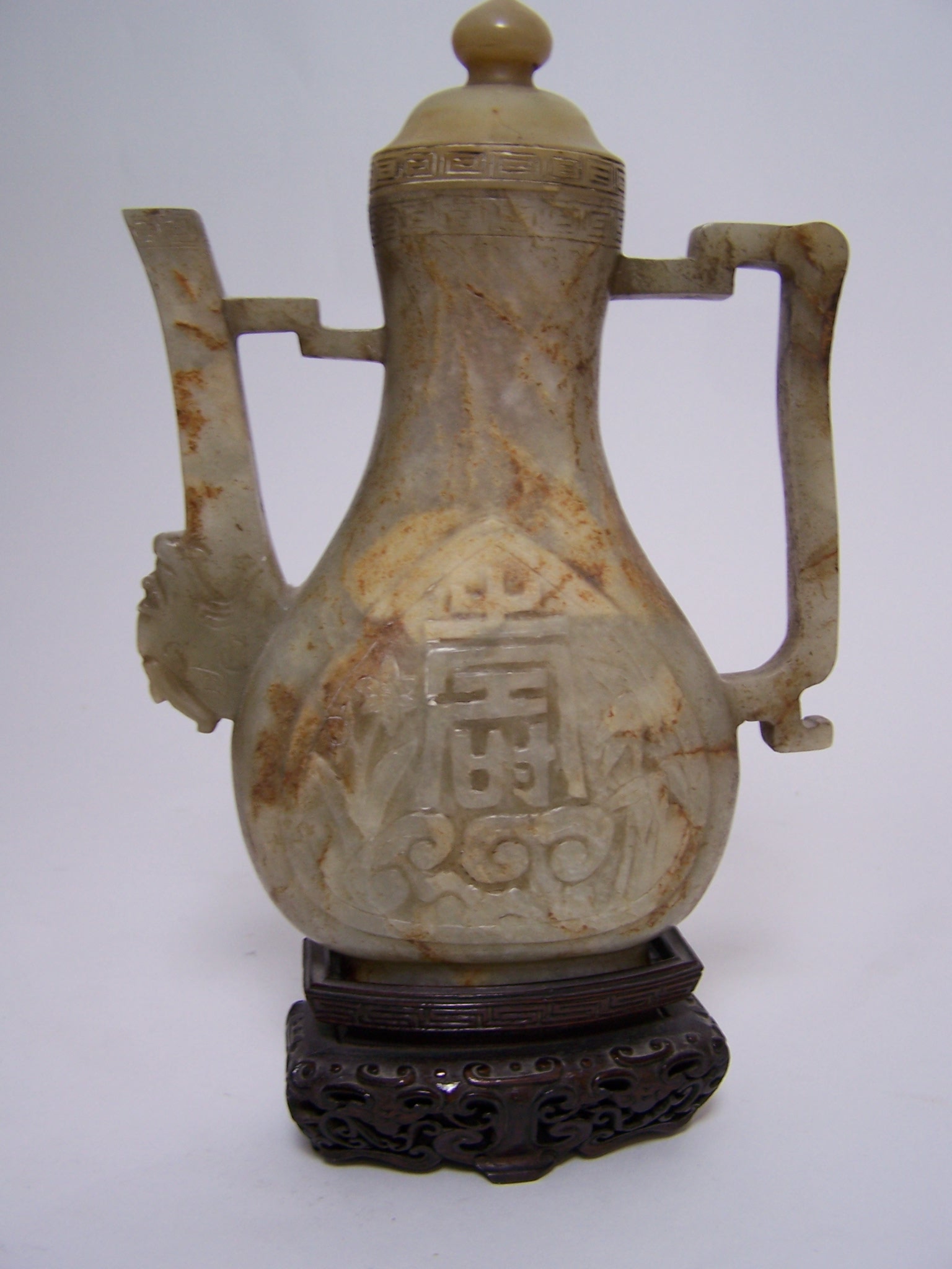 A Chinese mutton fat jade flattened baluster wine ewer and cover