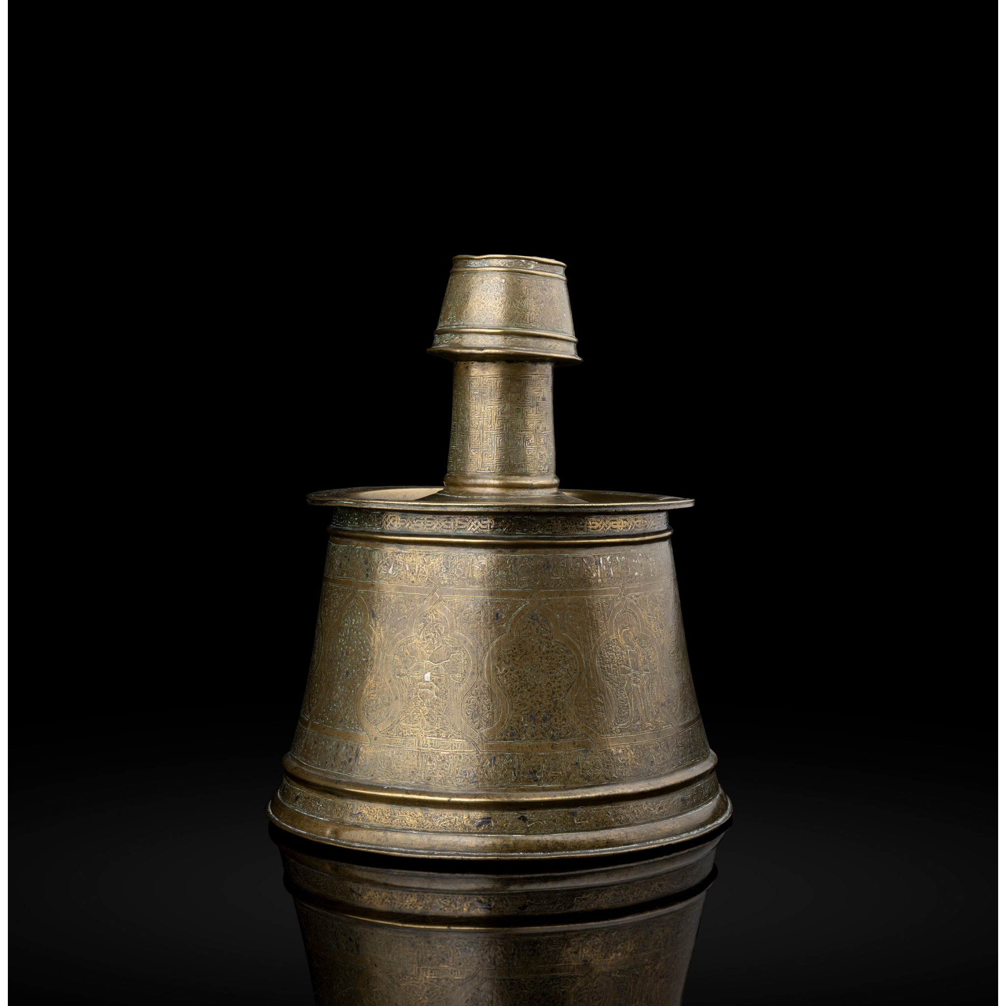 AN IMPORTANT MOSUL SILVER-INLAID BRASS CANDLESTICK