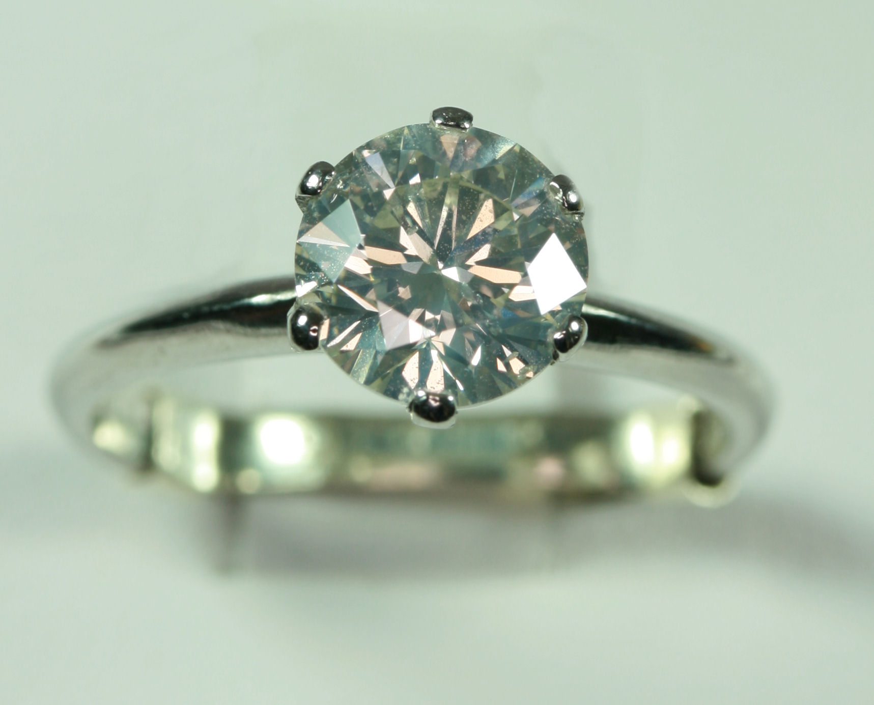 A contemporary platinum mounted diamond single-stone ring,