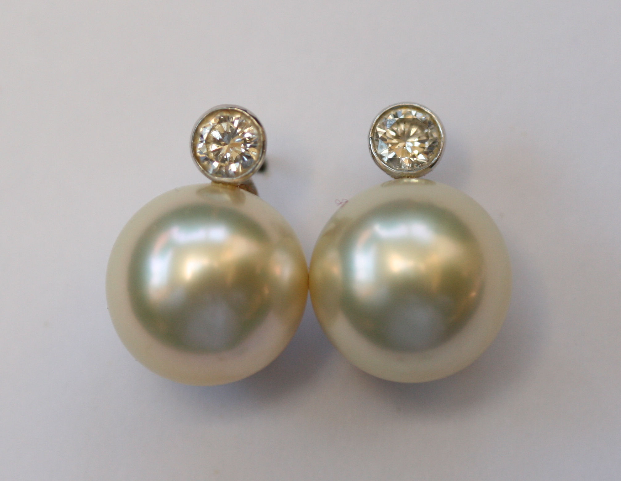 A pair of pearl and diamond ear studs