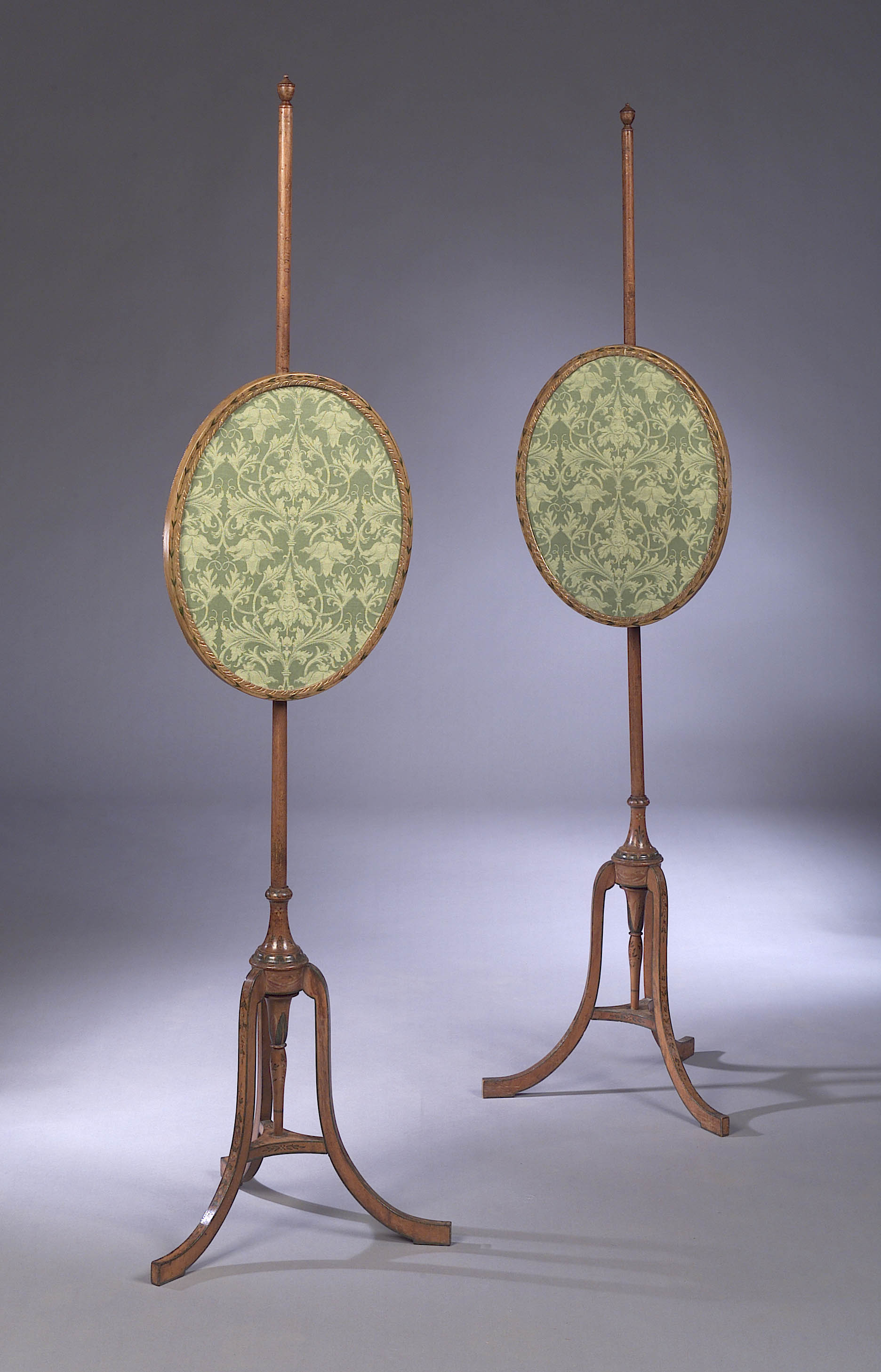 A pair of Edwardian painted satinwood polescreens