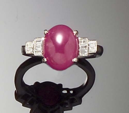 A cabochon ruby and diamond ring,