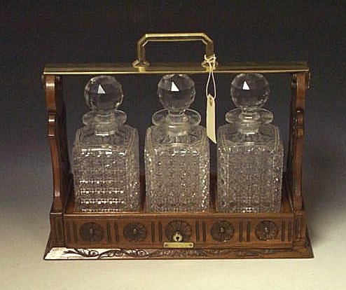 A late Victorian walnut and cut glass tantalus,