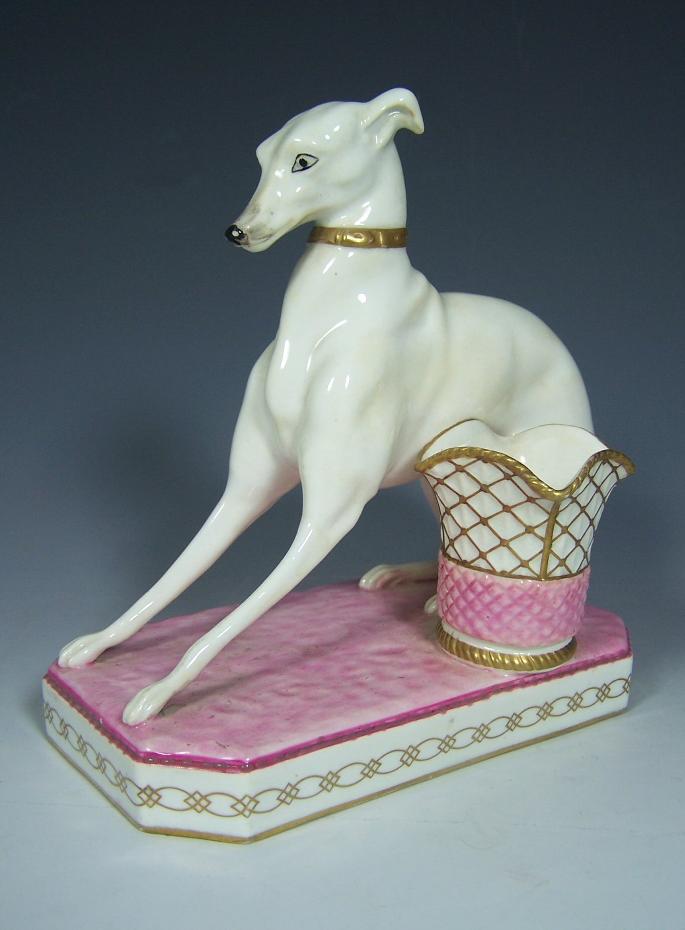 A 19th century porcelain greyhound and basket form match-holder Possibly Graingers Worcester
