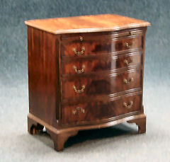 A mahogany serpentine gentlemans chest
