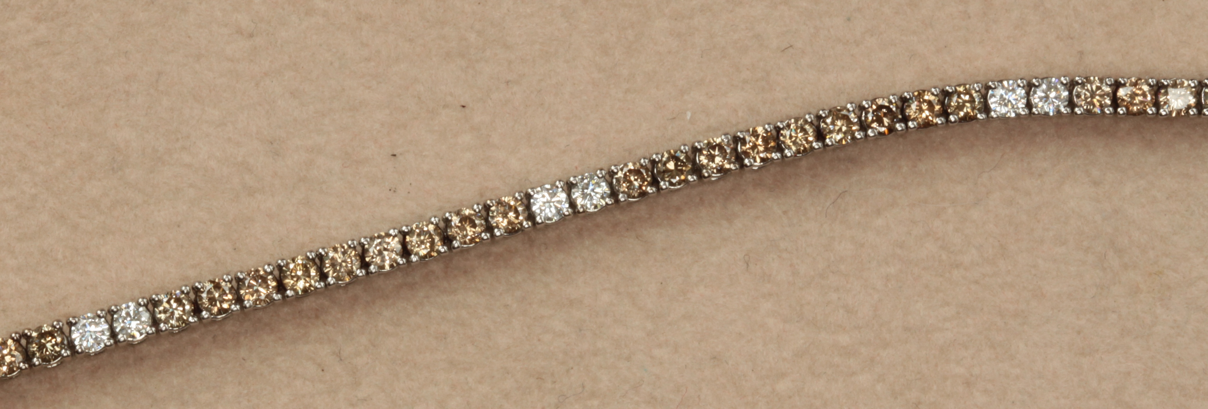 A fancy brown and colourless diamond set line bracelet