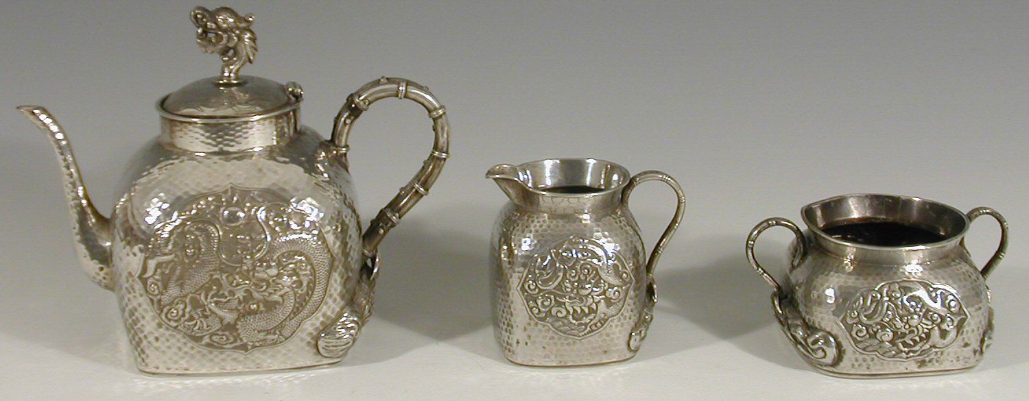 A late 19th century Chinese white metal three piece tea service,