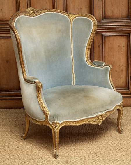 A 19th century French giltwood and upholstered wing armchair