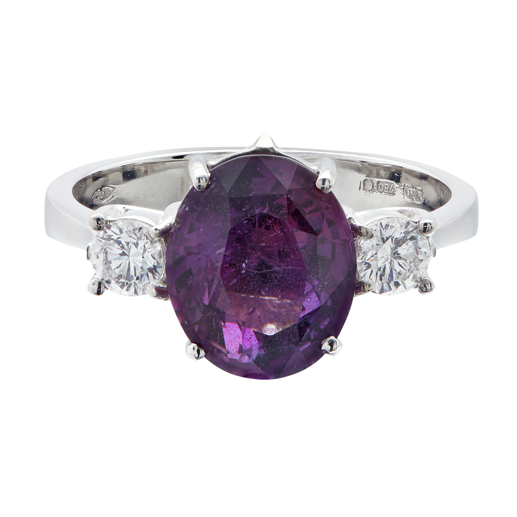 A pinkish-purple sapphire and diamond set ring