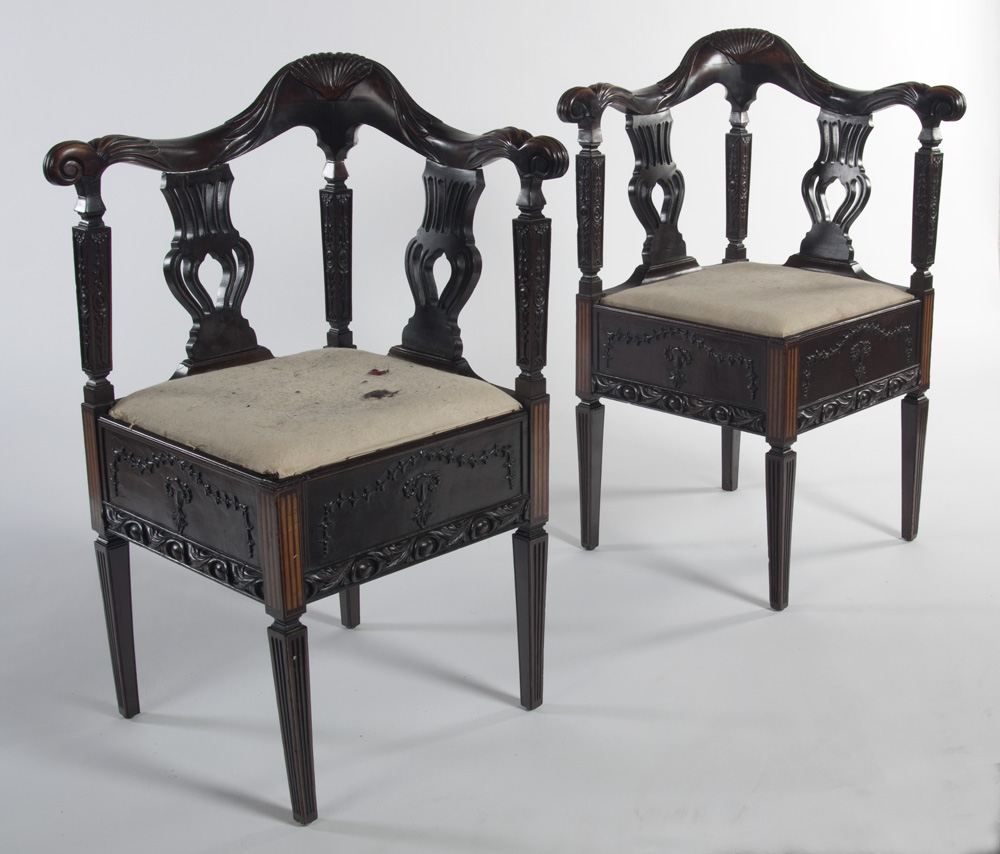 A pair of late 19th century stained mahogany corner chairs
