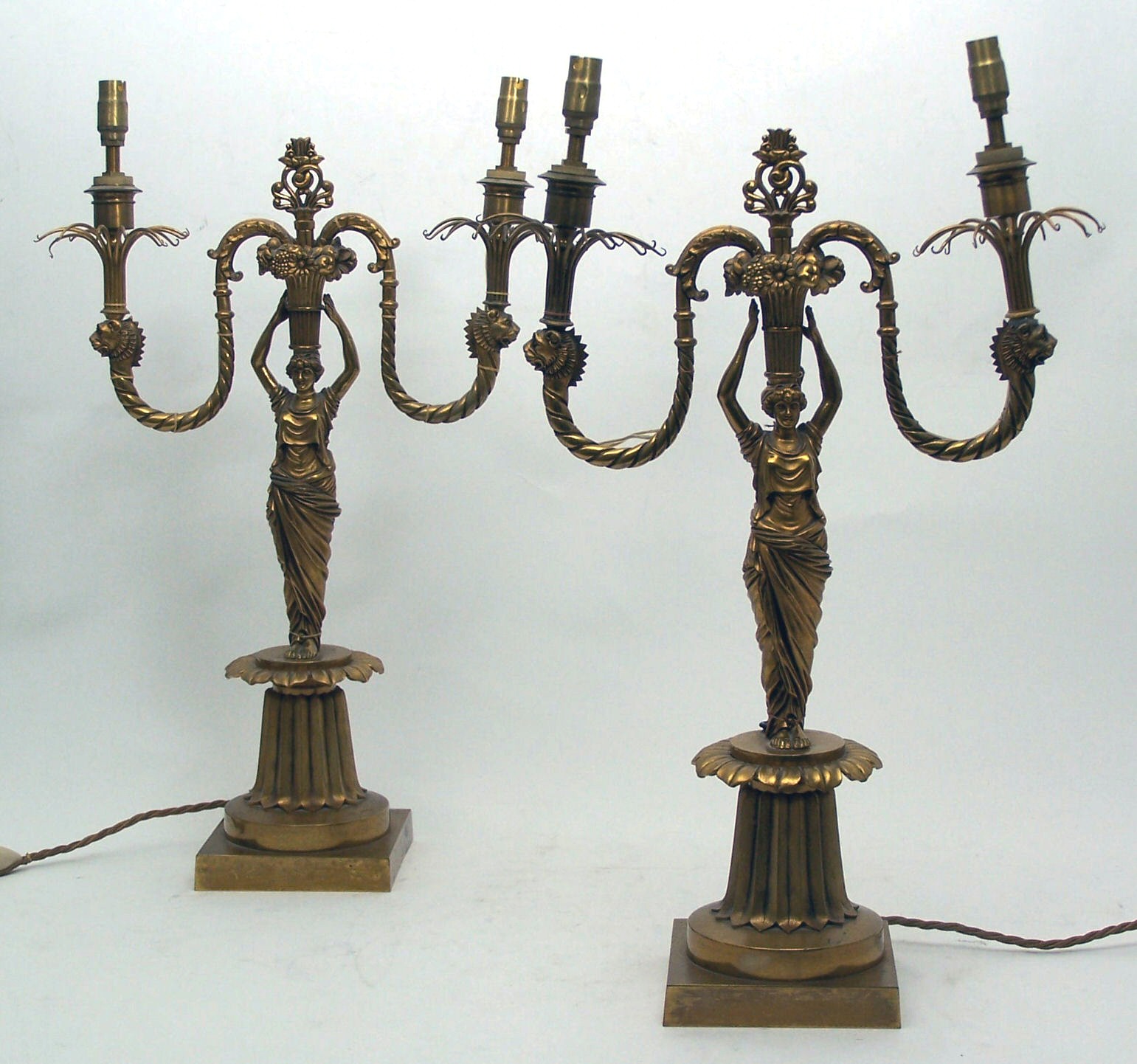 A pair of Regency style gilt bronze twin branch candelabra