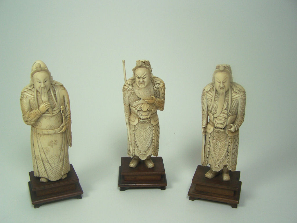 A set of three late 19th/early 20th century Chinese ivory warriors