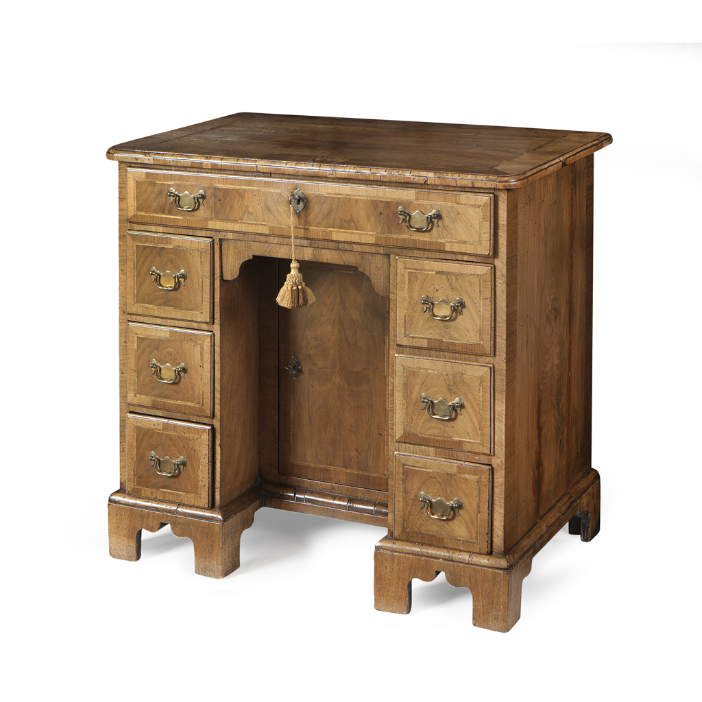 A GEORGE I WALNUT AND FEATHER BANDED KNEEHOLE DESK