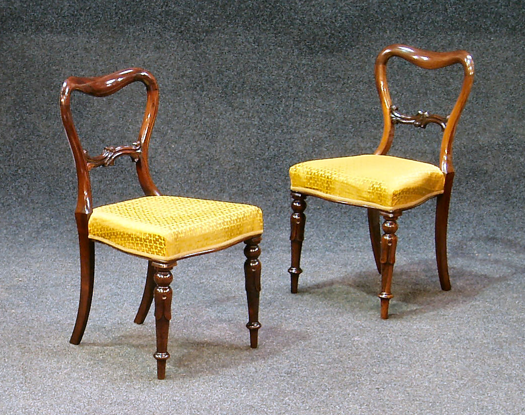 A set of four Victorian rosewood balloon back chairs,