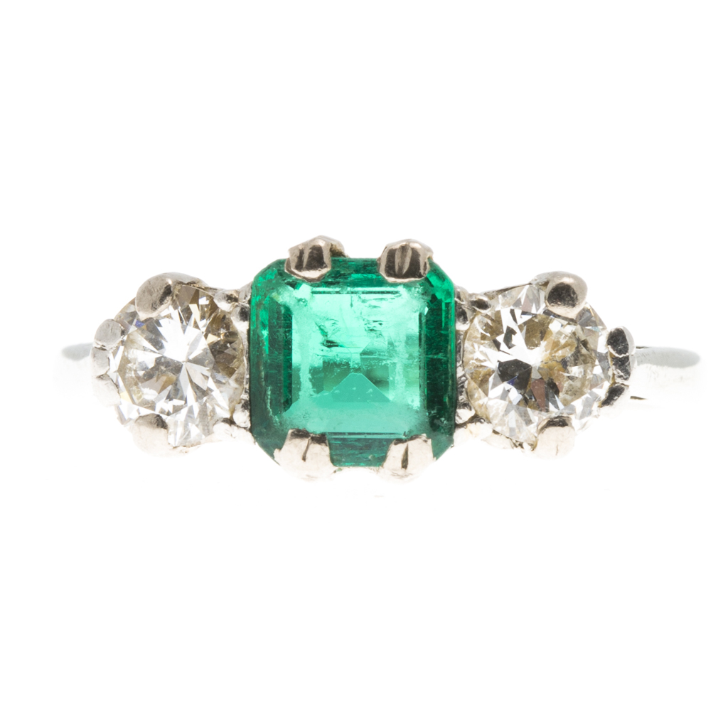 A three stone emerald and diamond set ring