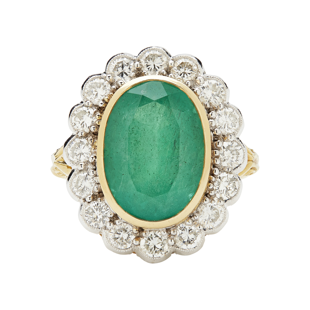 An emerald and diamond set cluster ring