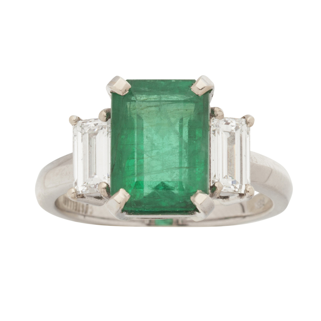 A Columbian emerald and diamond set three-stone ring