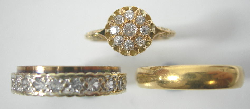 An 18ct gold mounted circular cluster ring,