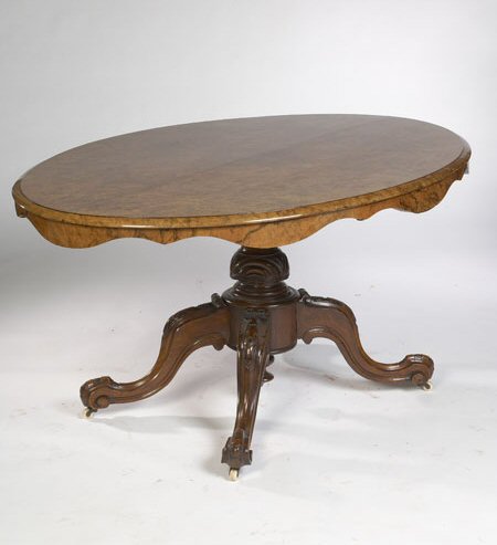 A Victorian period burr walnut oval tilt top loo table
