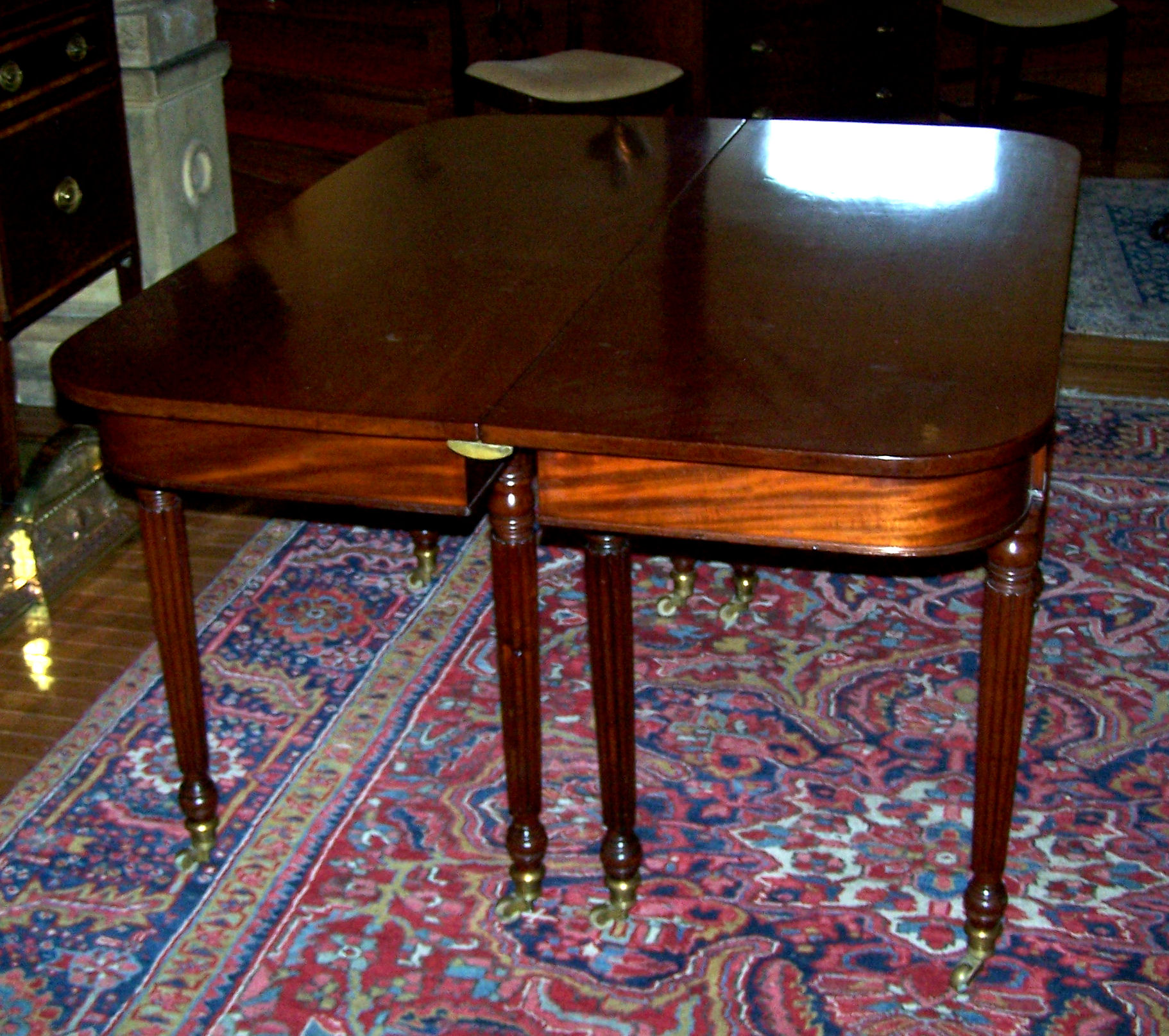 A Regency mahogany extending dining table In the manner of Gillows of Lancaster