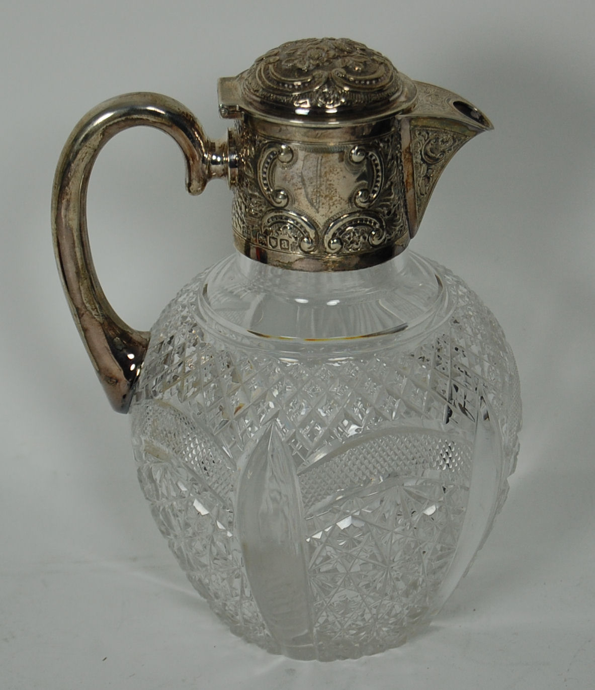 A Victorian silver mounted crystal claret jug