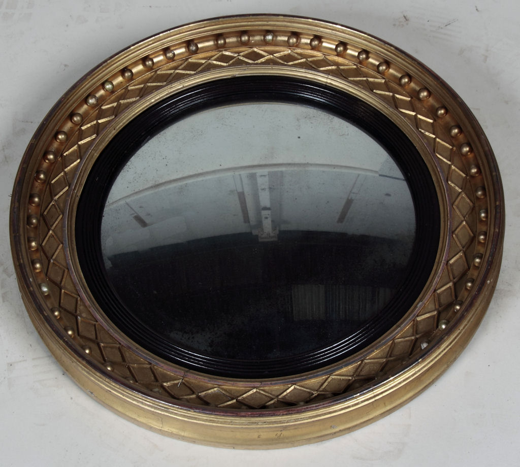 A Regency style giltwood convex wall mirror