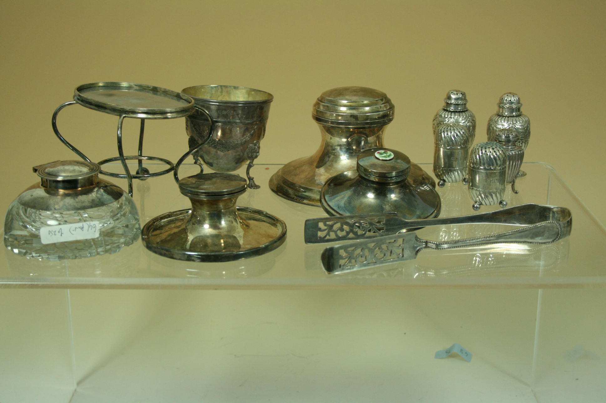 A silver capstan table inkwell