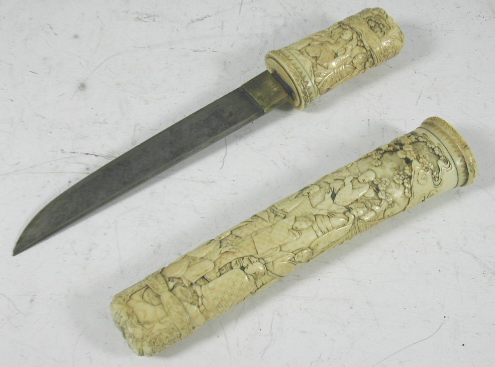 A Japanese dagger with fine carved ivory decorated hilt,
