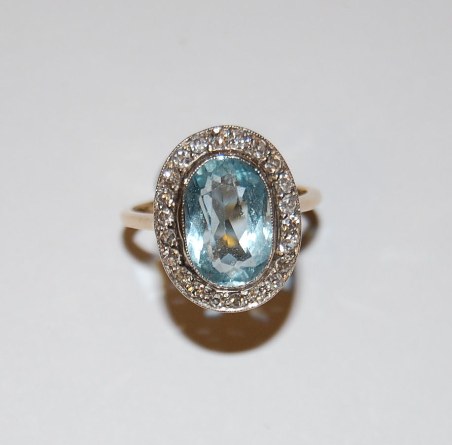 An early 20th century aquamarine and diamond cluster ring