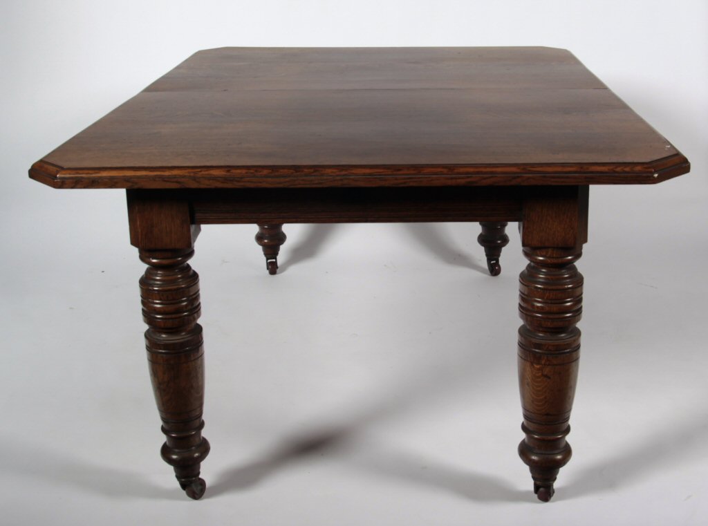 A Victorian oak extending dining table