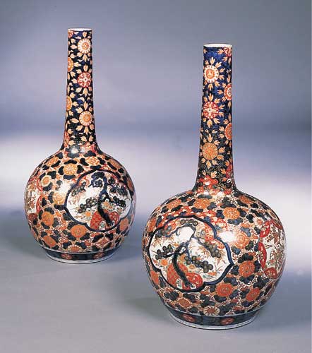 A large pair of Japanese Imari bottle vases