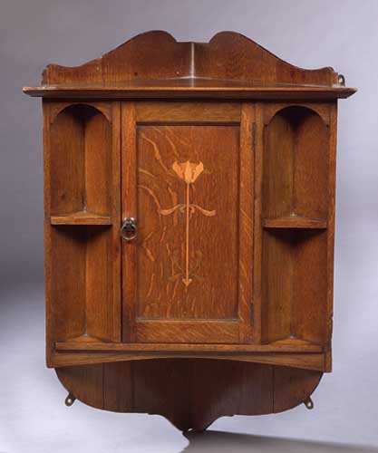 A Scottish Arts and Crafts oak corner cupboard