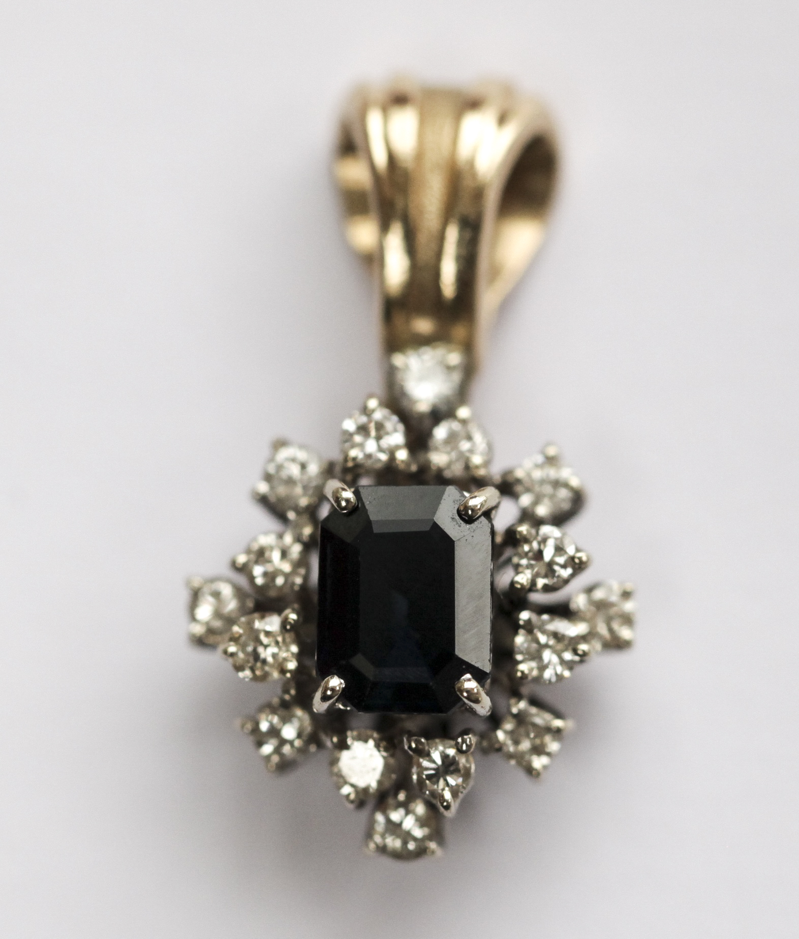 A sapphire and diamond cluster pendant