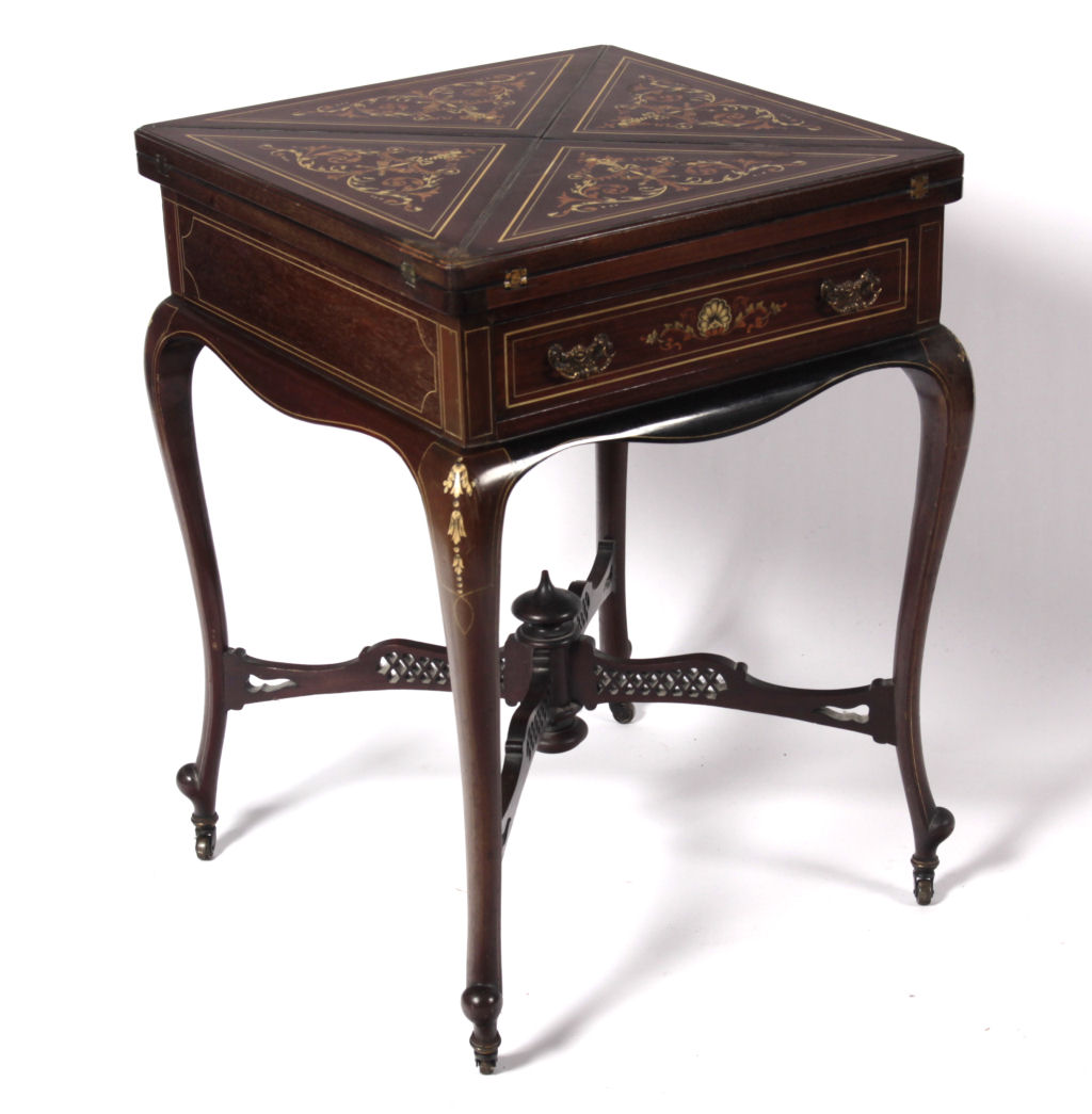 A late Victorian mahogany marquetry envelope games table