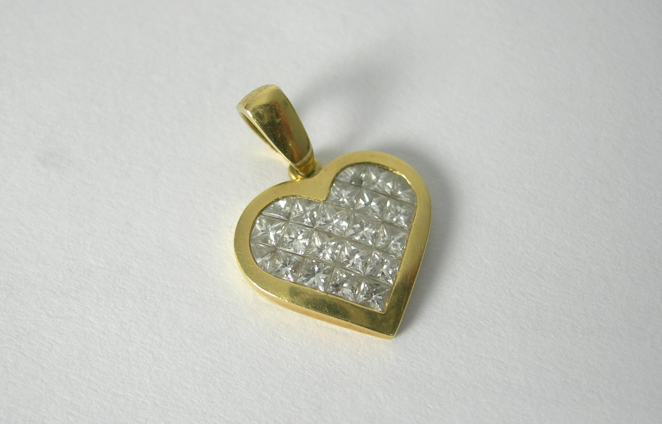 A heart shaped diamond set pendant,