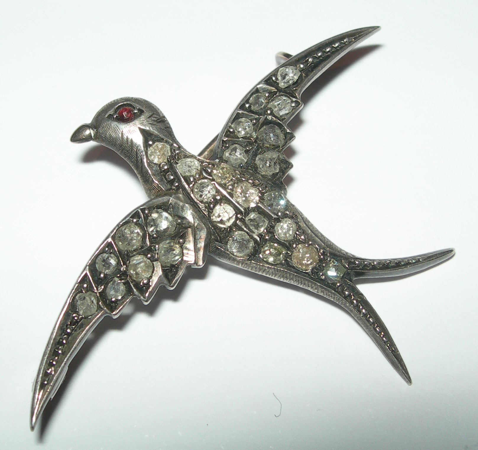 An Edwardian swallow form brooch,