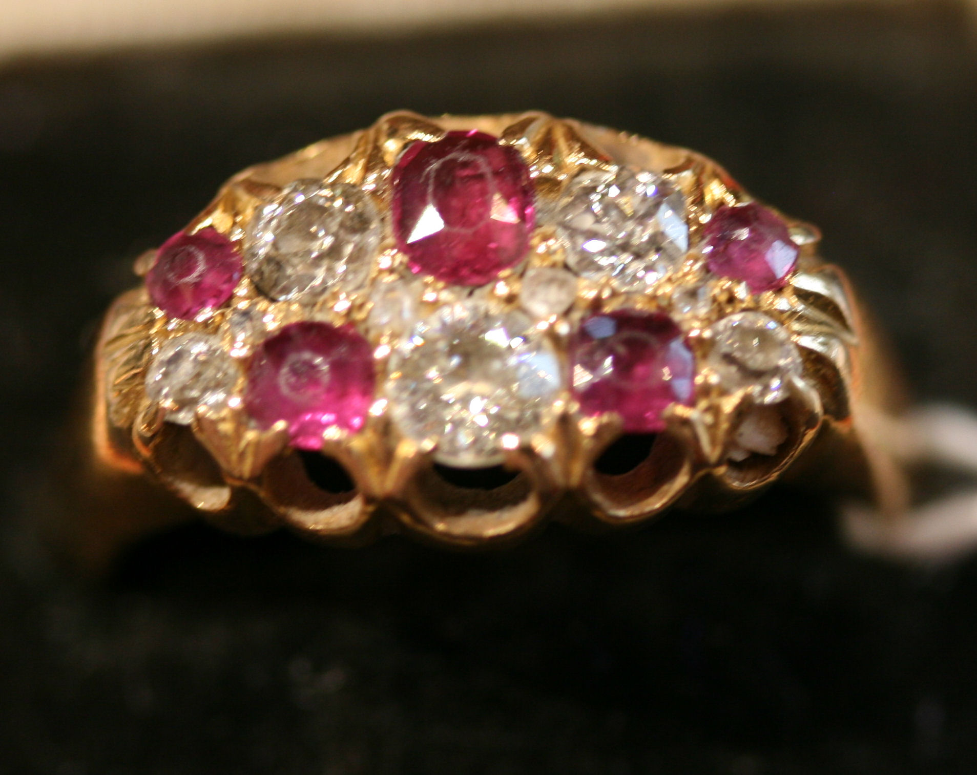 An Edwardian 18ct gold mounted ruby and diamond cluster ring