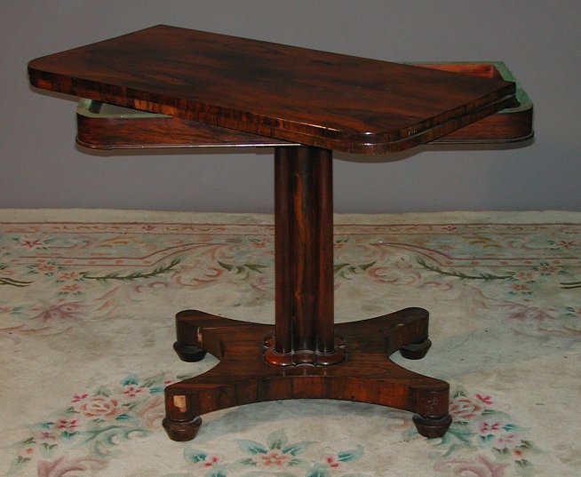 An early 19th century rosewood fold over tea table