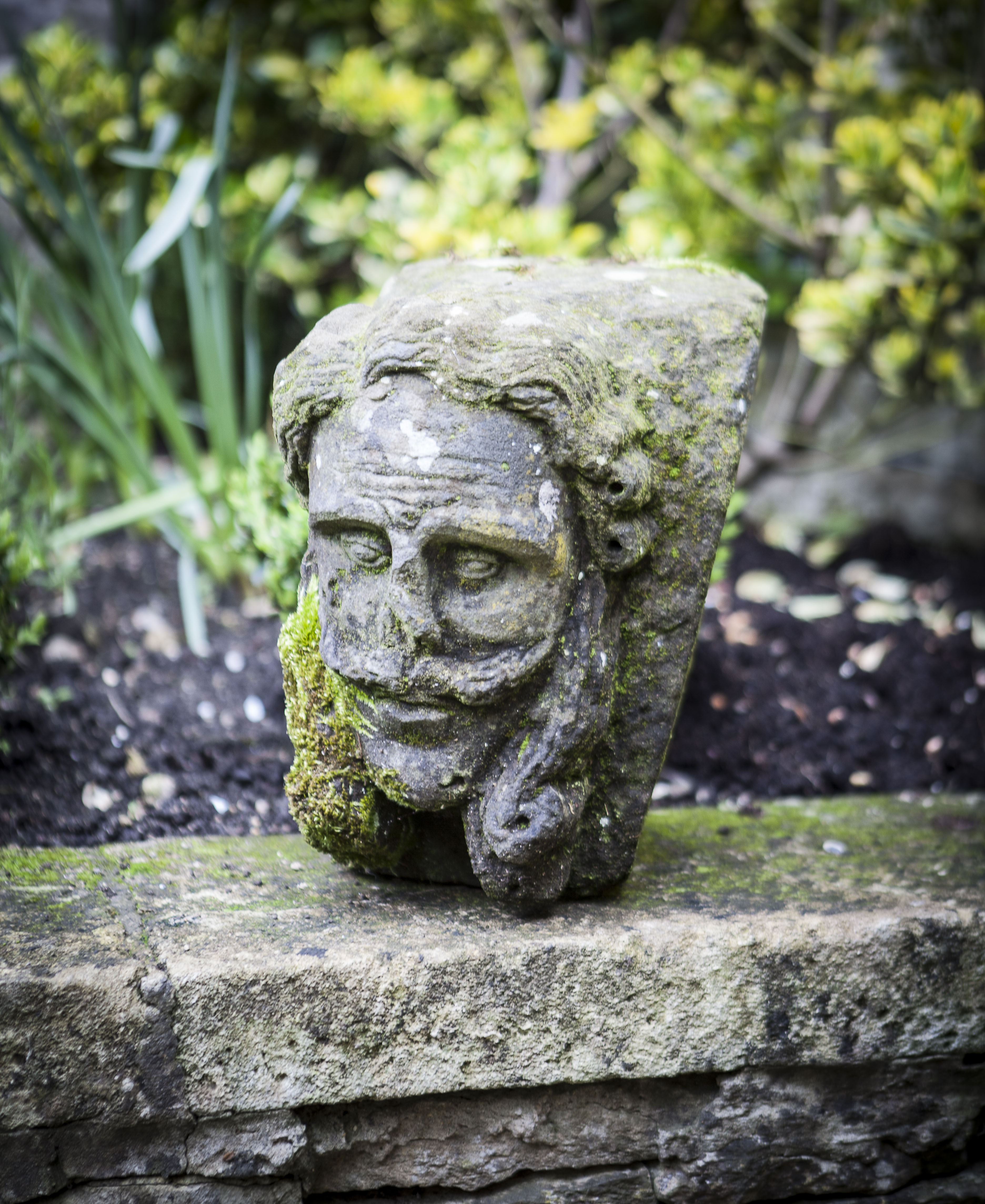 CARVED STONE CORBEL IN THE FORM OF A MAN'S HEAD