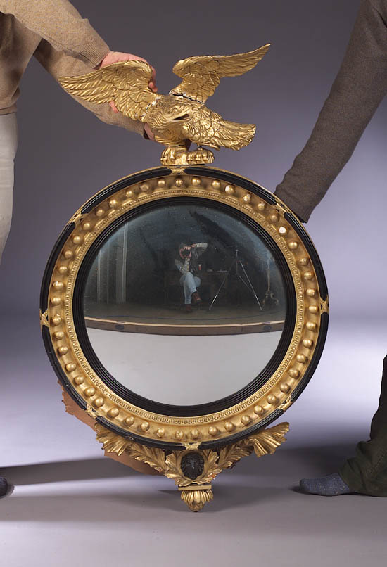 A gilt and ebonised convex mirror