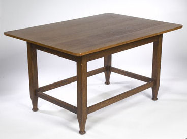 An oak dining table By Harris Lebus